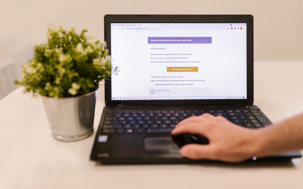 Person reading an email on a laptop in an office setting