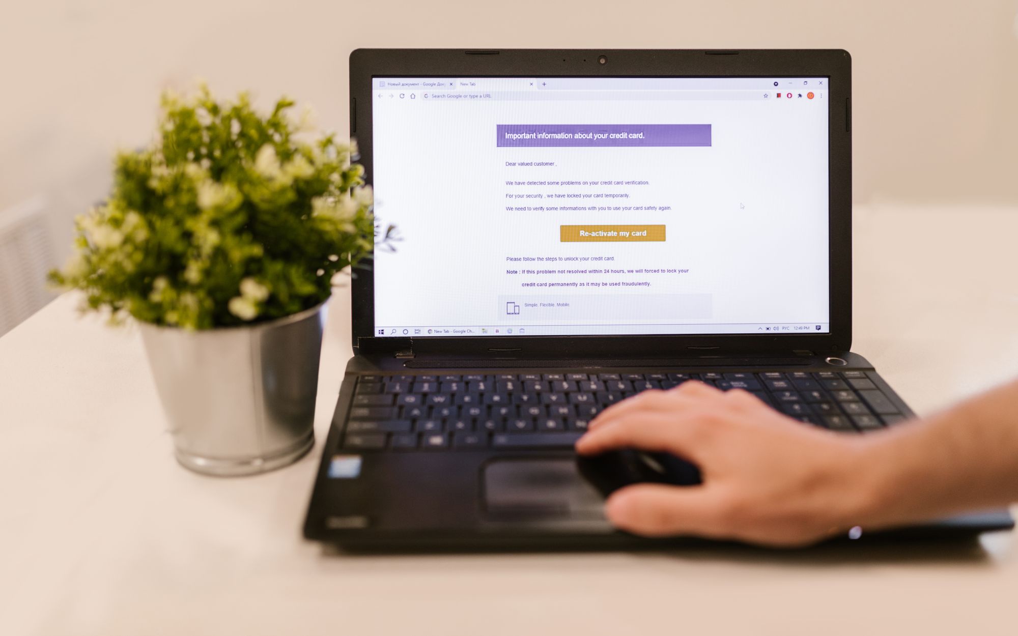 Person reading an email on a laptop in an office setting